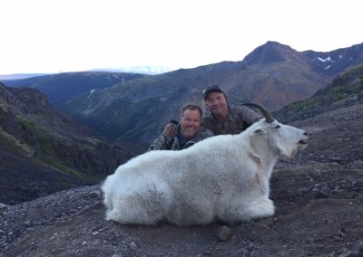 Hunters with dead mountain goat
