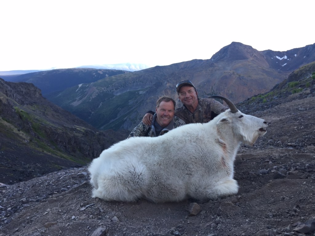 Hunters with dead mountain goat