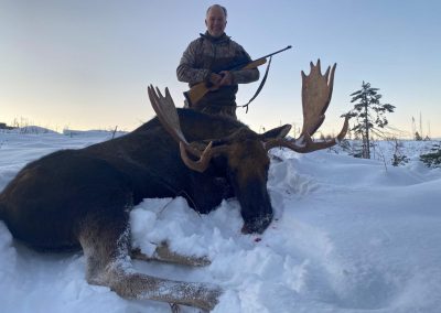 Hunter with dead moose