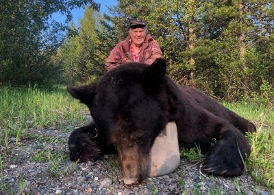 Hunters with dead bear
